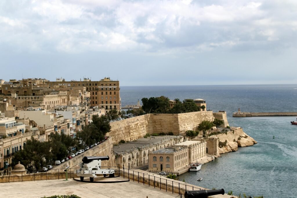 Explore the stunning waterfront and historic architecture of Valletta, Malta, captured in a vibrant daytime shot.