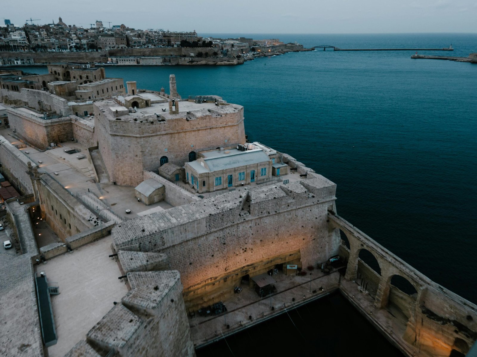 Drone shot of the historic Fort Saint Angelo overlooking the sea in Il-Birgu, Malta.