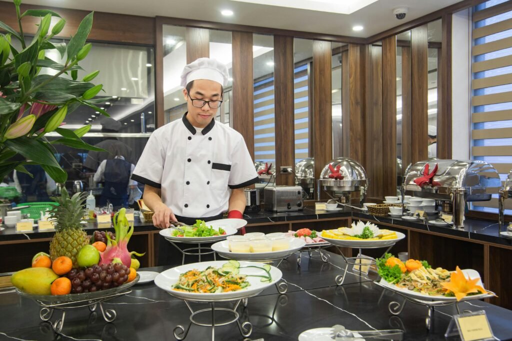 Chef preparing a buffet with various dishes at a hotel in Hanoi, Vietnam.